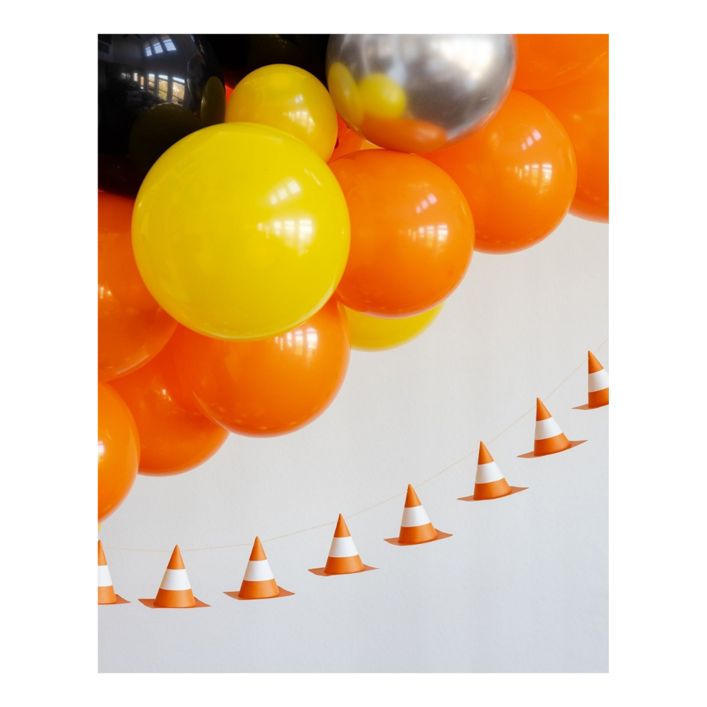 Yellow orange and silver balloon arch with traffic cone garland for construction birthday from Parte Haus party supply store in Bethesda Maryland