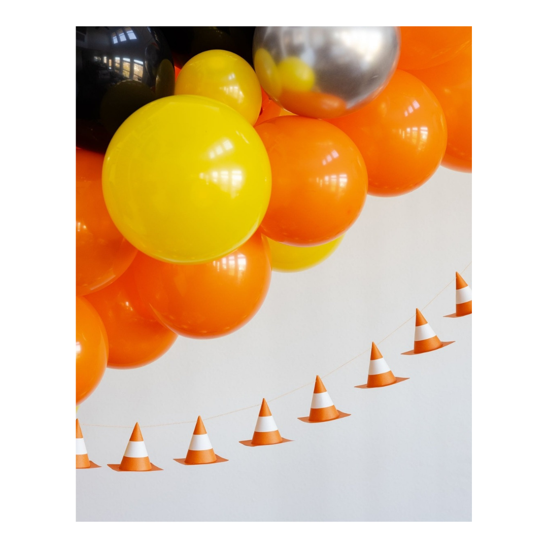 Yellow orange and silver balloon arch with traffic cone garland for construction birthday from Parte Haus party supply store in Bethesda Maryland