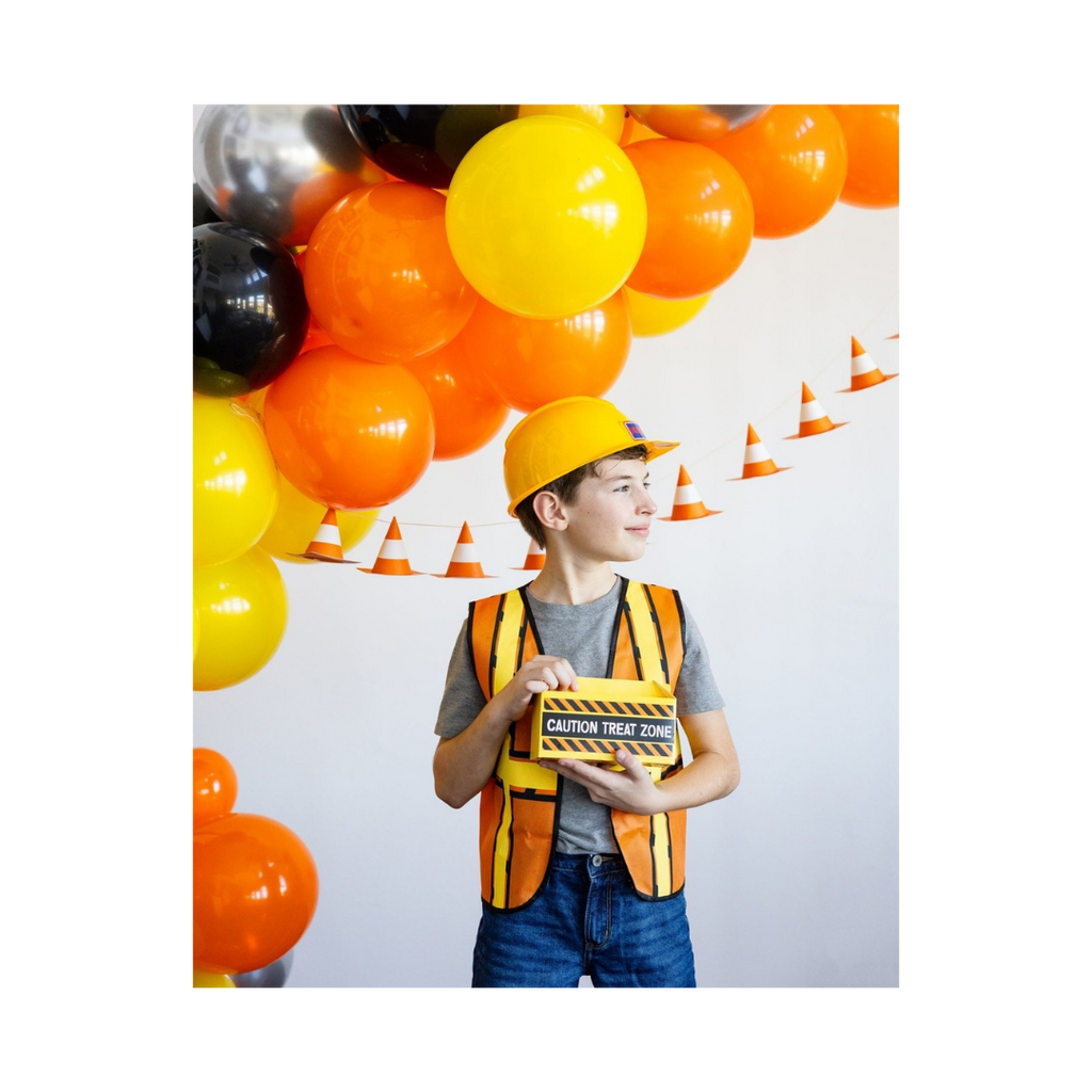 Yellow and orange construction theme balloon arch with child in vest and hat birthday from Parte Haus party supply store in Bethesda Maryland