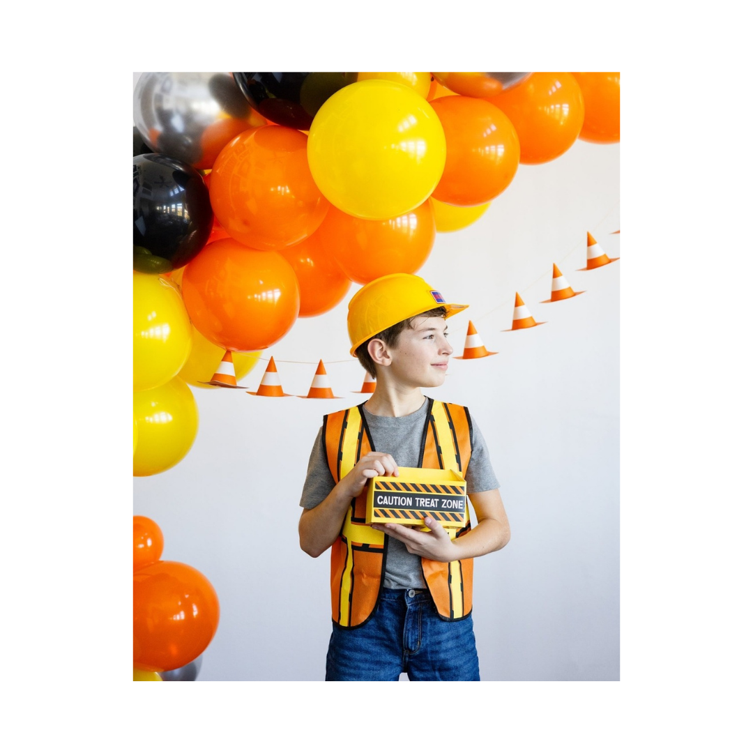 Yellow and orange construction theme balloon arch with child in vest and hat birthday from Parte Haus party supply store in Bethesda Maryland