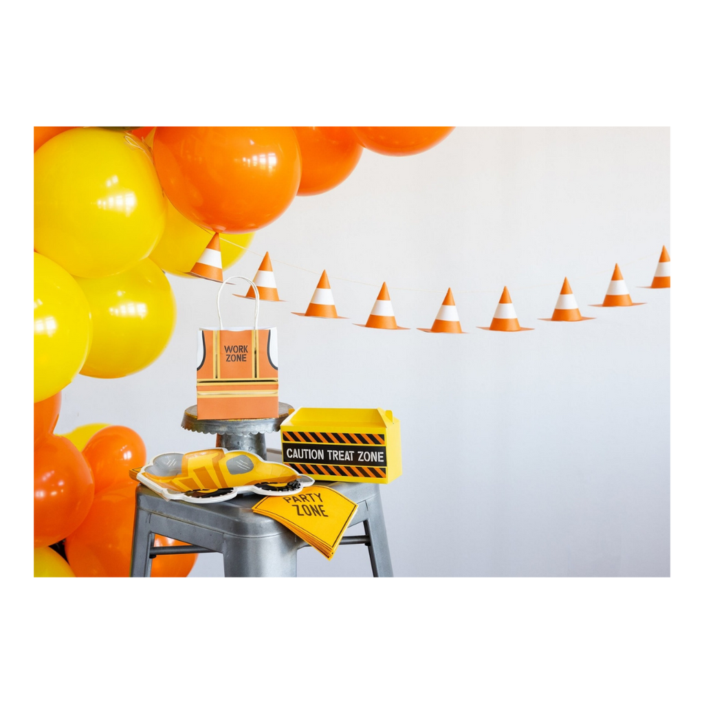 Yellow orange construction themed decorations with balloons and treat bags for birthday party from Parte Haus party supply store in Bethesda MD