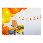 Yellow orange construction themed decorations with balloons and treat bags for birthday party from Parte Haus party supply store in Bethesda MD