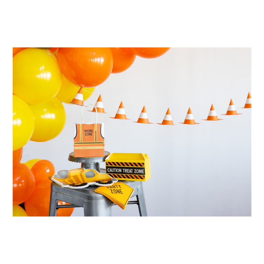 Yellow orange construction themed decorations with balloons and treat bags for birthday party from Parte Haus party supply store in Bethesda MD