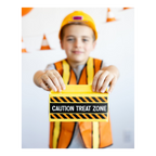 Orange construction costume kid with yellow Caution Treat Zone card birthday party from Parte Haus party supply store in Bethesda Maryland
