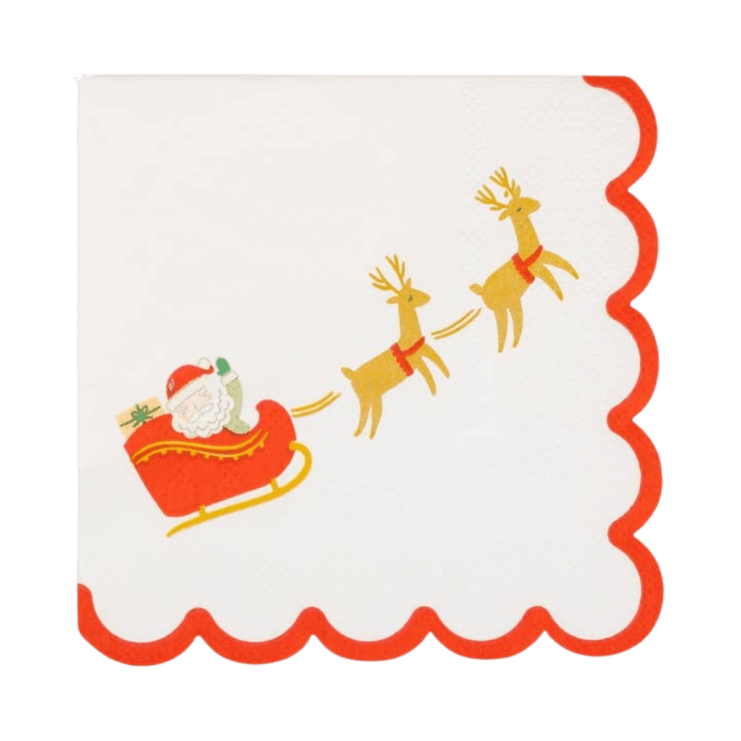 White red Christmas napkin with scalloped edge Santa in sleigh and reindeer from Parte Haus party supply store in Bethesda Maryland