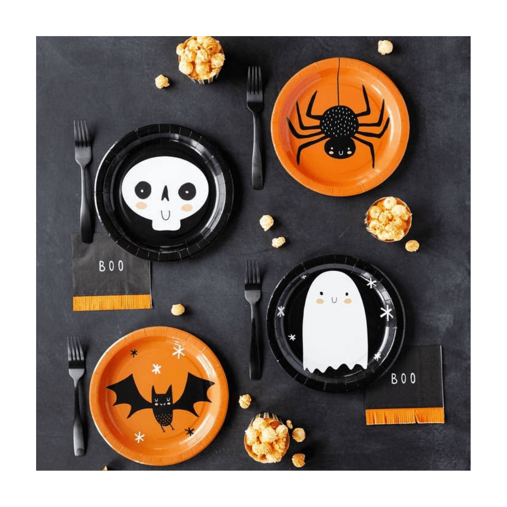 Orange and black Halloween themed paper plates with skeleton spider ghost and bat design from Parte Haus party supply store in Bethesda Maryland