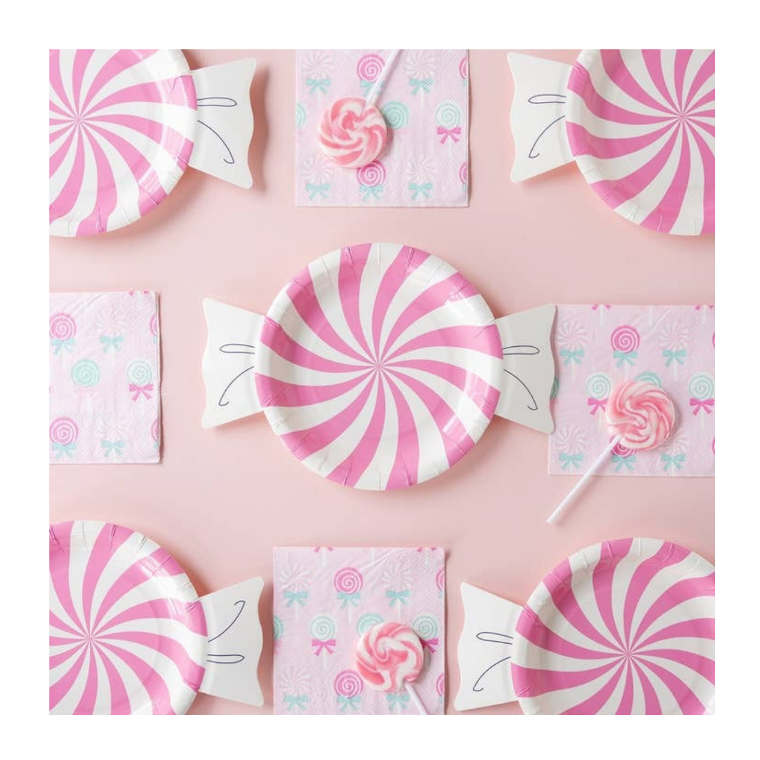 Pink swirl candy paper plates and matching napkins with lollipops for birthday from Parte Haus party supply store in Bethesda Maryland