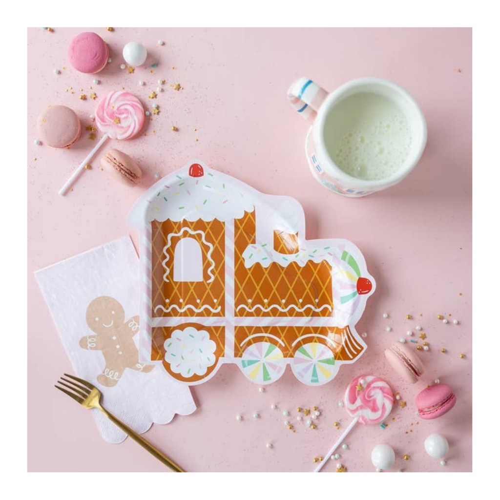 Brown gingerbread train shaped paper plate for Christmas with candy and milk from Parte Haus party supply store in Bethesda Maryland