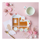 Brown gingerbread train shaped paper plate for Christmas with candy and milk from Parte Haus party supply store in Bethesda Maryland