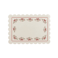 Ivory Christmas placemat with red bows and holly border from Parte Haus party supply store in Bethesda Maryland