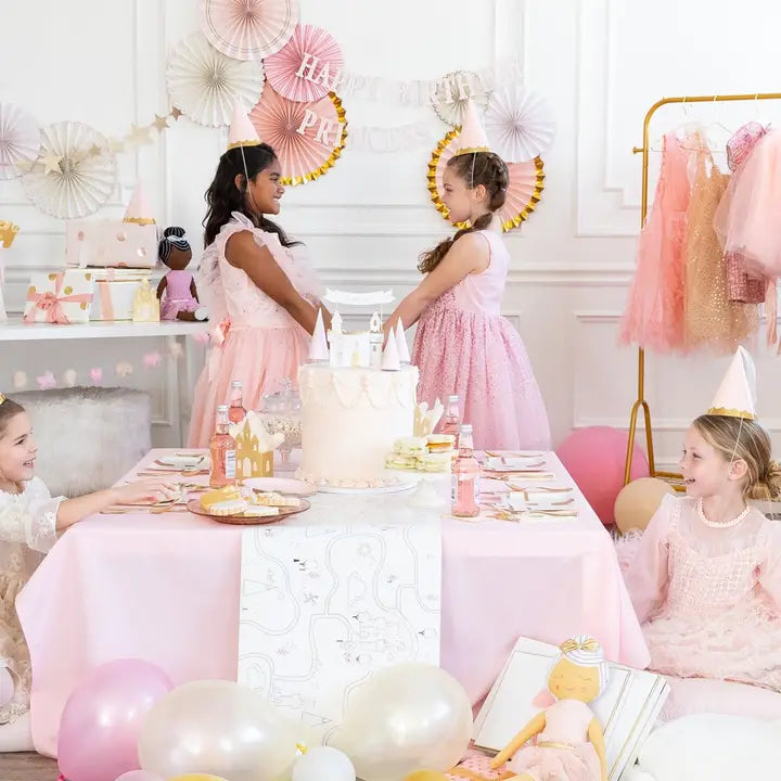 Pink princess happy birthday banner with girls in pastel dresses at party from Parte Haus party supply store in Bethesda, MD.