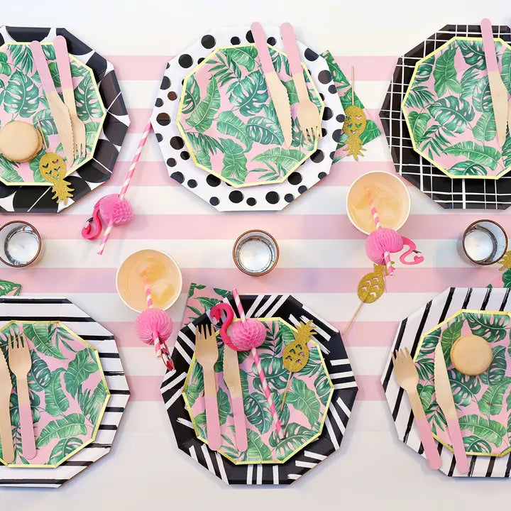 Pale pink wooden cutlery set on tropical leaf plates for summer birthday from Parte Haus party supply store in Bethesda MD