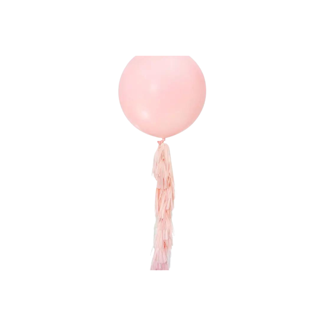 Pastel pink balloon with paper tassel tail for birthday decor from Parte Haus party supply store in Bethesda Maryland