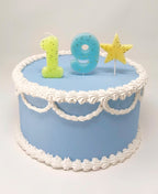 pastel glitter number birthday candles on blue cake for birthday theme from Parte Haus party supply store in Bethesda MD