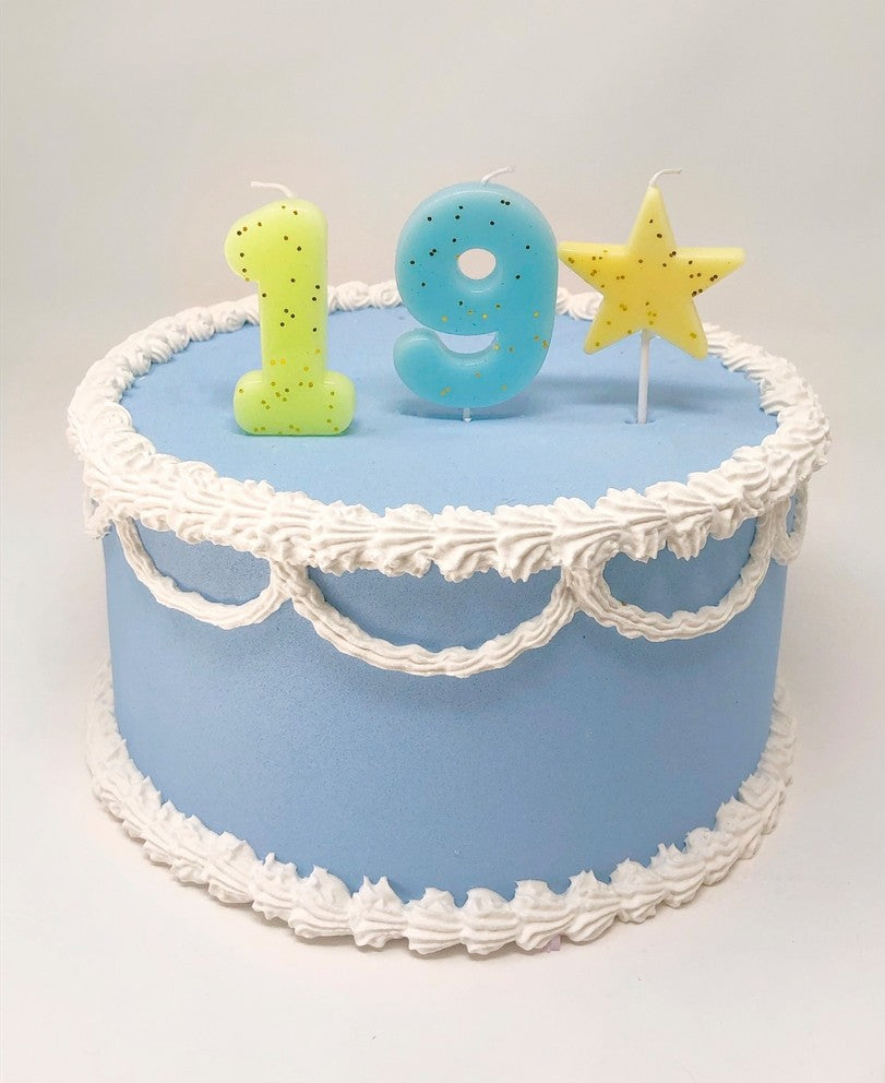 pastel glitter number birthday candles on blue cake for birthday theme from Parte Haus party supply store in Bethesda MD
