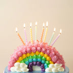 Pastel twisted birthday candles on a rainbow cake for birthday celebration from Parte Haus party supply store in Bethesda Maryland