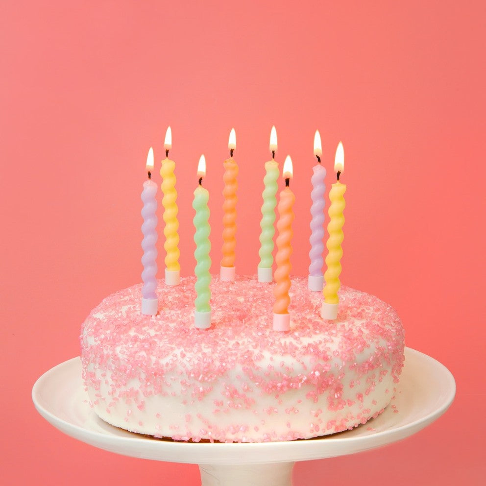 Pastel twisted birthday candles on pink cake for birthday from Parte Haus party supply store in Bethesda Maryland