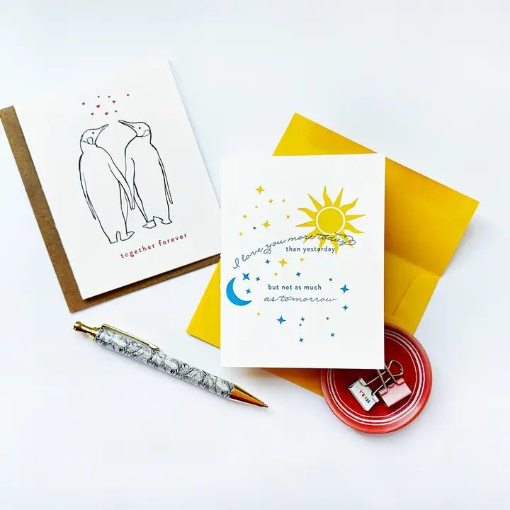 White and yellow anniversary and love greeting cards with penguin illustration Parte Haus party supply store in Bethesda Maryland
