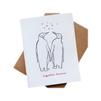 White love anniversary card with two penguins holding hands Valentine design from Parte Haus party supply store in Bethesda Maryland