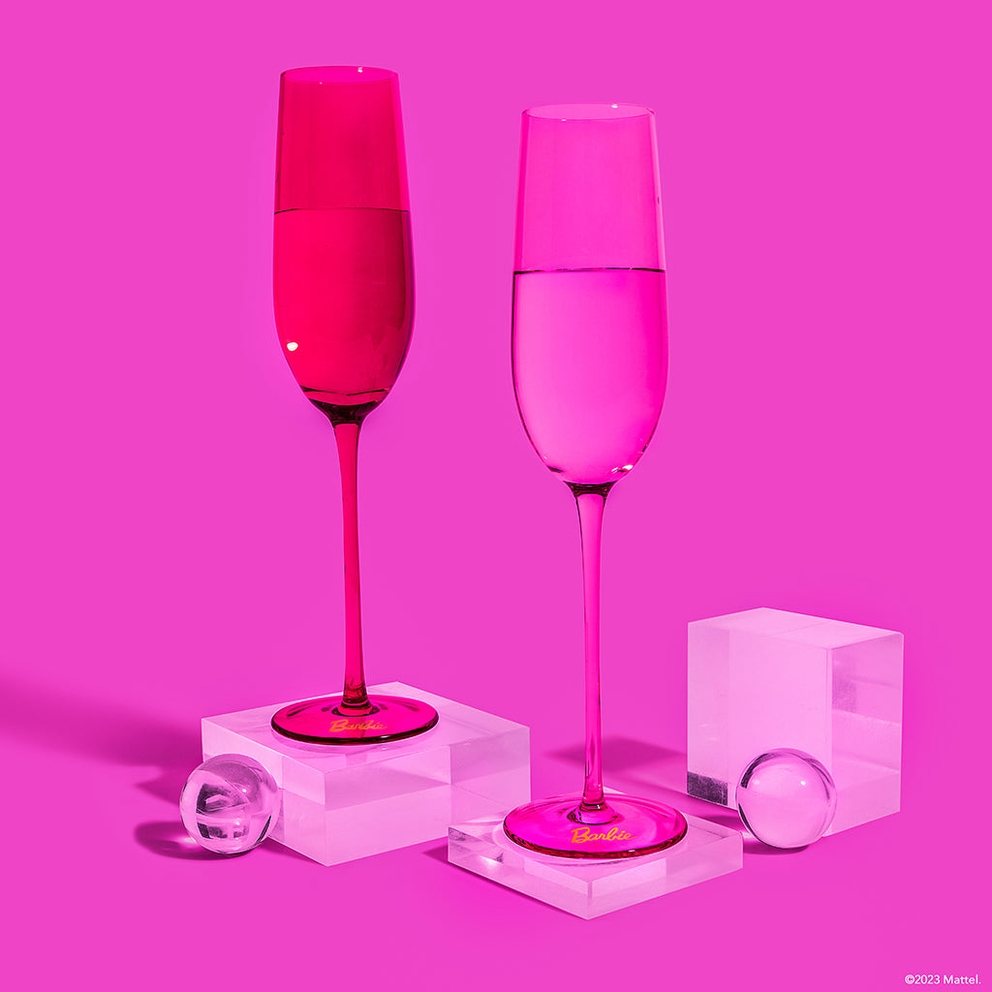 Pink Barbie champagne flutes with clear bases on a pink background birthday theme from Parte Haus party supply store in Bethesda MD