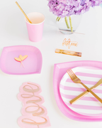 Pink and white striped large dinner plate with gold cutlery on birthday table from Parte Haus party supply store in Bethesda Maryland