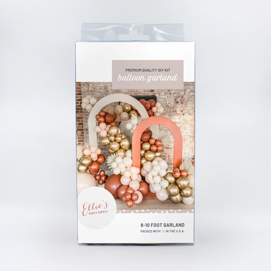Burnt orange balloon arch kit with gold and white garland boho birthday decor from Parte Haus party supply store in Bethesda Maryland
