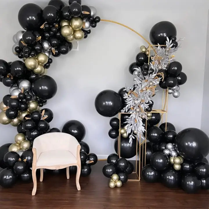 Black and gold balloon arch kit with elegant chair for birthday from Parte Haus party supply store in Bethesda MD