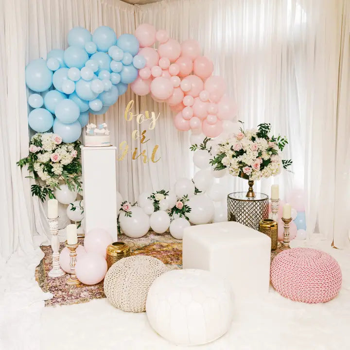 Blue and pink balloon arch with floral decor for gender reveal from Parte Haus party supply store in Bethesda MD