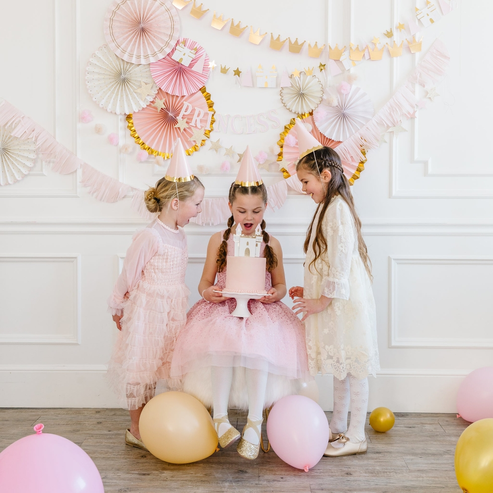 Pink and gold princess party hats on children at a birthday celebration from Parte Haus party supply store in Bethesda Maryland