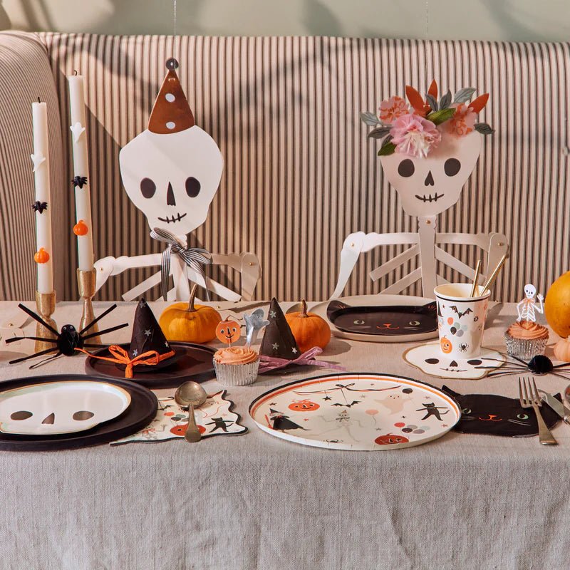 Orange and black Halloween skeleton table setting with pumpkins for Halloween from Parte Haus party supply store in Bethesda Maryland