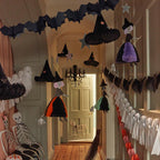 Black and orange witch Halloween decorations hanging in a hallway from Parte Haus party supply store in Bethesda MD