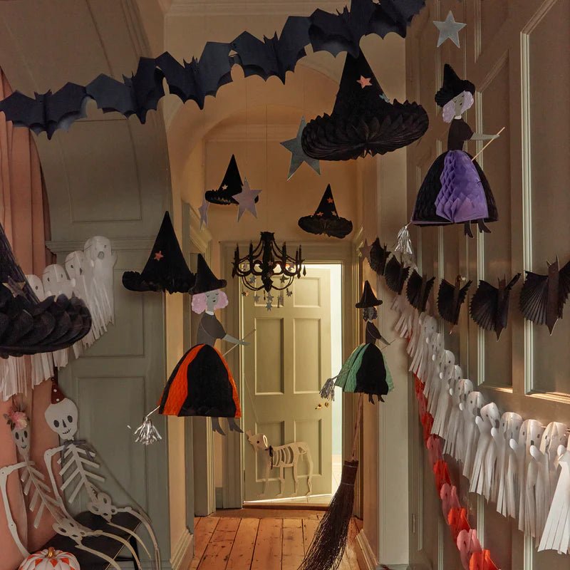 Black and orange witch Halloween decorations hanging in a hallway from Parte Haus party supply store in Bethesda MD