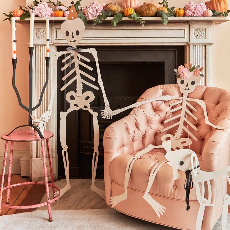 White skeleton Halloween decoration with party hats sitting in cozy living room from Parte Haus party supply store in Bethesda, Maryland