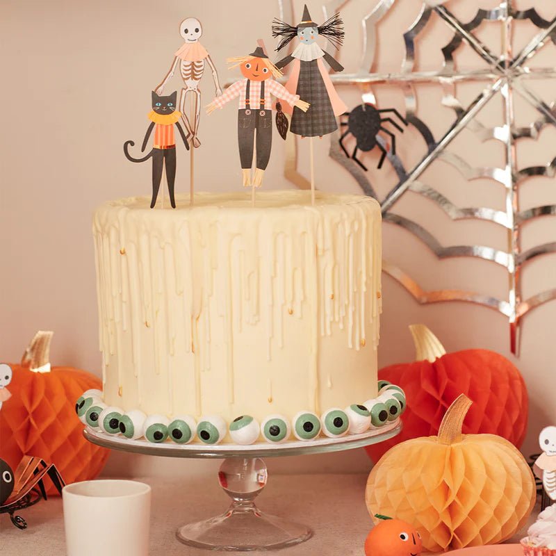 White Halloween cake with spooky toppers and eyeball decorations for Halloween from Parte Haus party supply store in Bethesda Maryland.