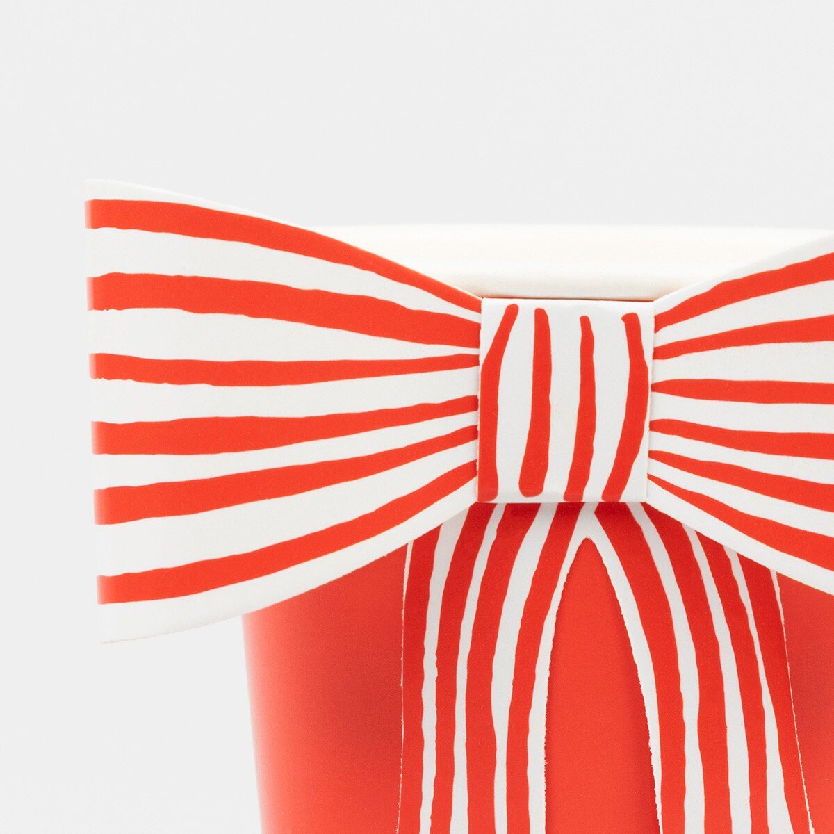 Red and white striped paper cup with bow detail for birthday celebration from Parte Haus party supply store in Bethesda MD