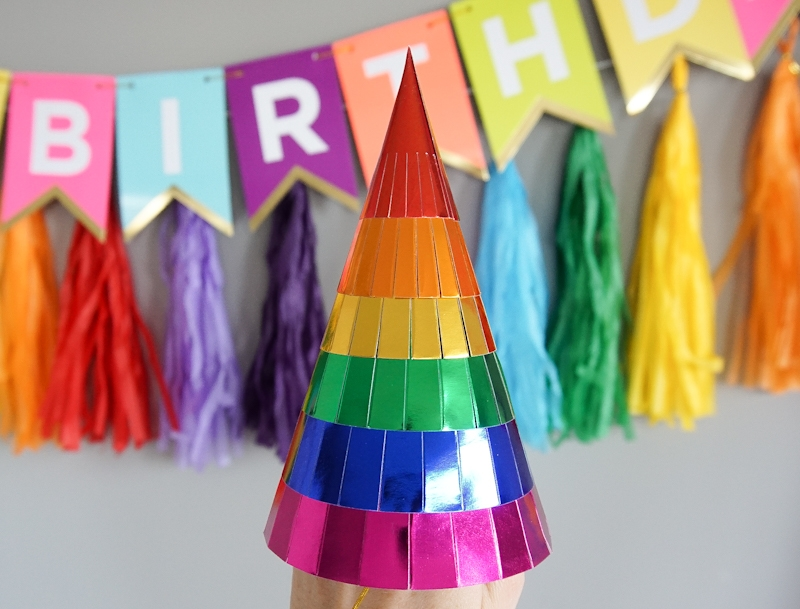 Rainbow striped party hat shiny cone for birthday from Parte Haus party supply store in Bethesda Maryland