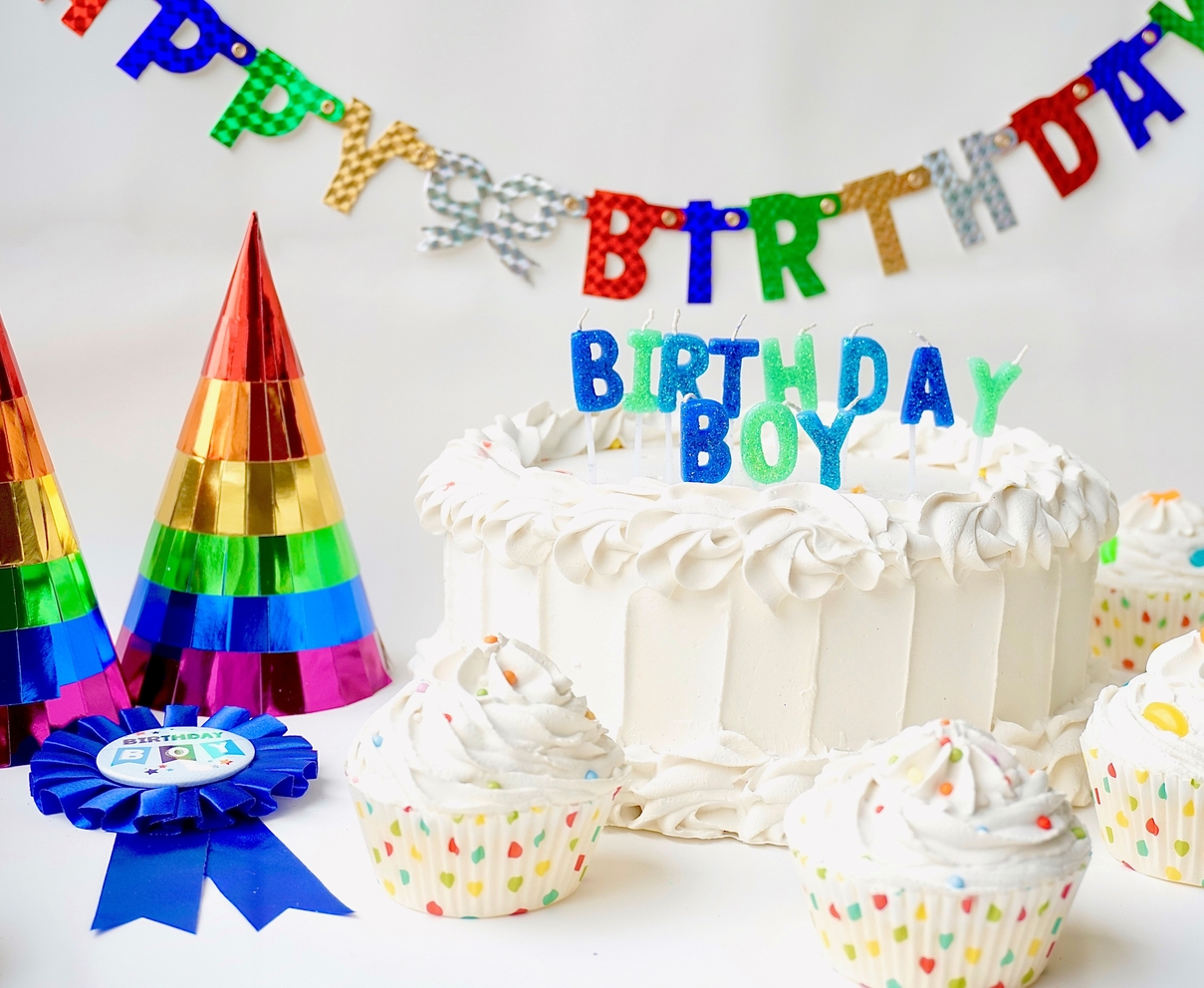 Rainbow party hats and white birthday cake for boy birthday from Parte Haus party supply store in Bethesda Maryland