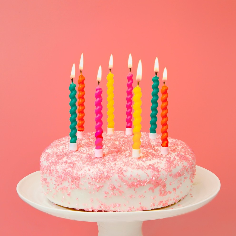 Rainbow twisted birthday candles on a cake for birthday celebration from Parte Haus party supply store in Bethesda, MD