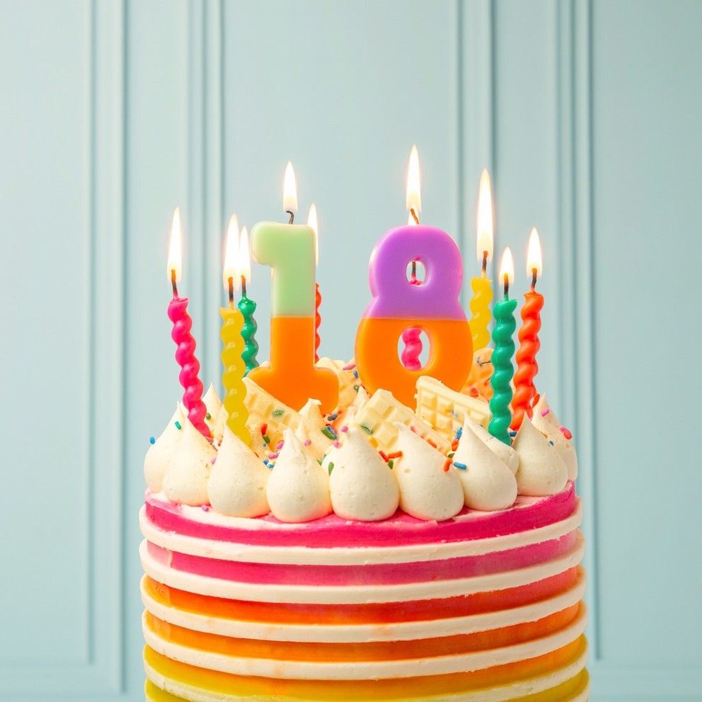 Rainbow twisted birthday candles on colorful cake for birthday from Parte Haus party supply store in Bethesda Maryland