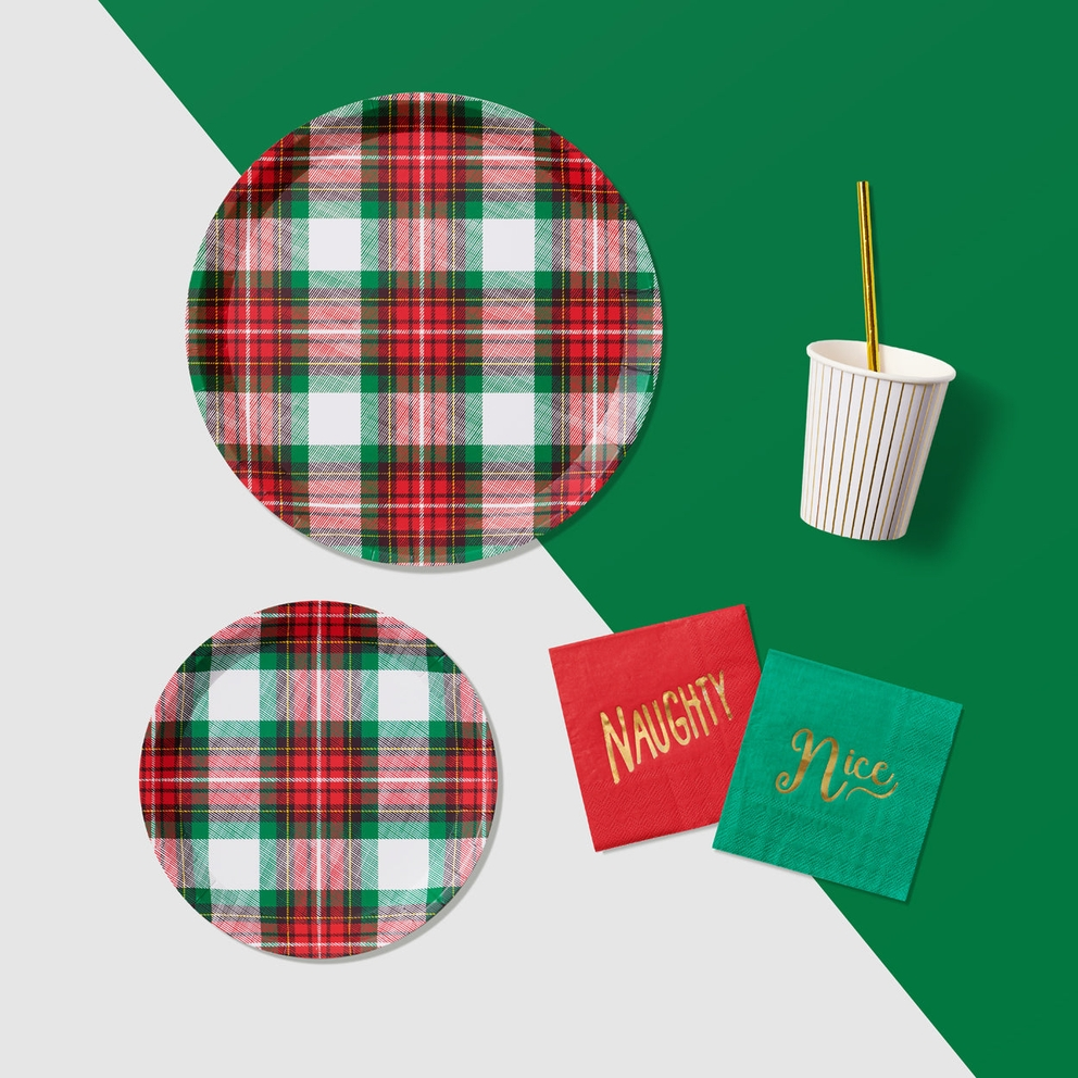 Red and green plaid plates with gold striped cup and festive napkins for Christmas from Parte Haus party supply store in Bethesda Maryland