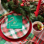 Red and green plaid plates with gold cutlery and pine decor Christmas from Parte Haus party supply store in Bethesda MD