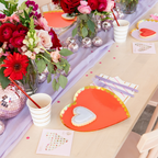 Red and lilac gold rimmed large dinner plates heart shaped on a romantic table Valentine’s Day from Parte Haus party supply store in Bethesda MD