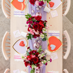Red and lilac gold rimmed large dinner plates heart shaped decor for romantic theme from Parte Haus party supply store in Bethesda MD
