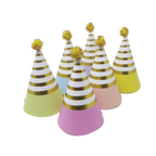 Pastel rainbow cone hats with gold stripes and pom poms birthday decor from Parte Haus party supply store in Bethesda MD