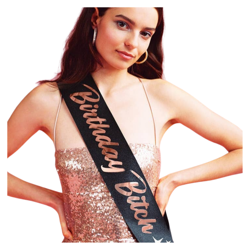 Black birthday sash with gold lettering worn by woman for birthday celebration from Parte Haus party supply store in Bethesda MD