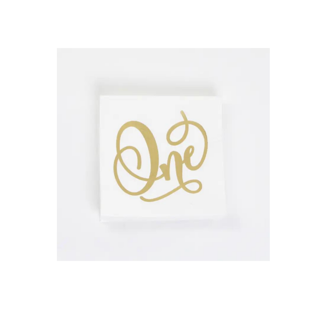 Gold and white napkin with One script for first birthday from Parte Haus party supply store in Bethesda MD