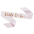 White bride to be sash with rose gold script for bridal shower from Parte Haus party supply store in Bethesda, Maryland
