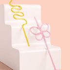 Yellow and pink reusable swirly straws with fun shapes birthday decor from Parte Haus party supply store in Bethesda MD