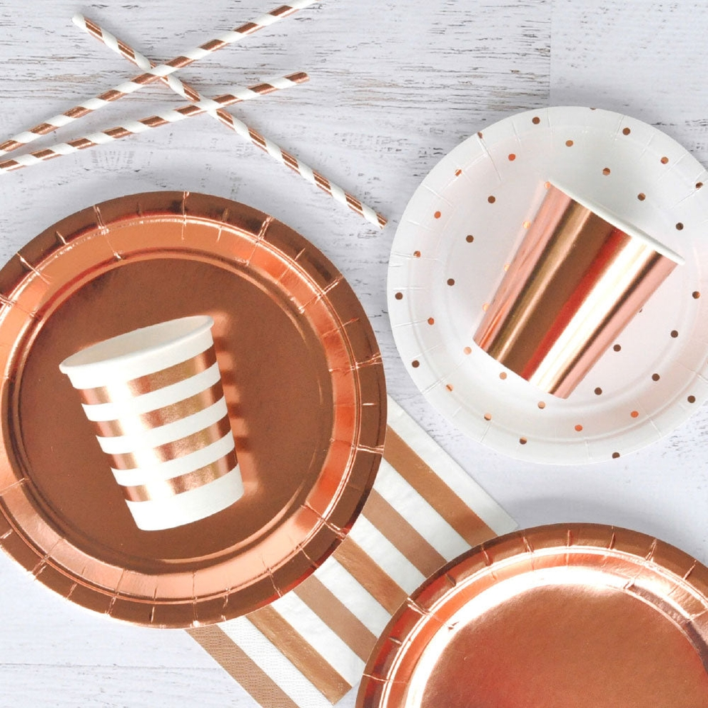 Rose gold dinner plates striped cups and polka dot napkins for elegant birthday from Parte Haus party supply store in Bethesda MD