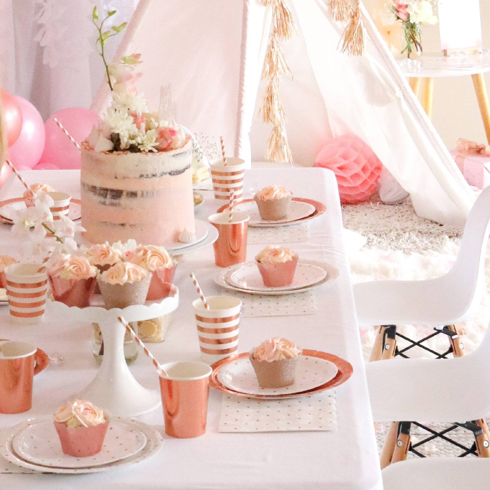 Rose gold large dinner plates with metallic rim on birthday table from Parte Haus party supply store in Bethesda MD